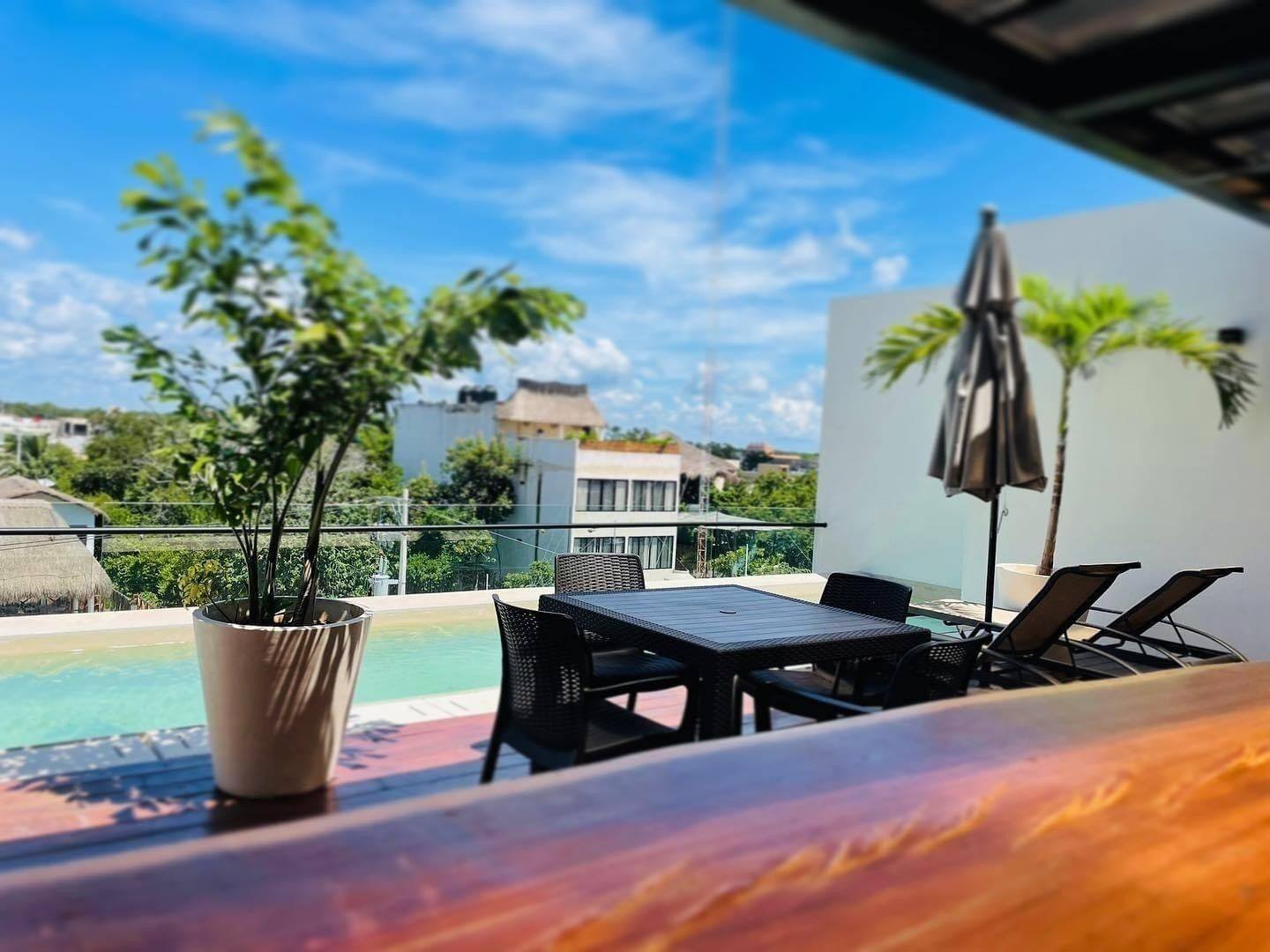 Moonshine Tulum Hotel: rooftop pool with outdoor furniture and views over the neighborhood