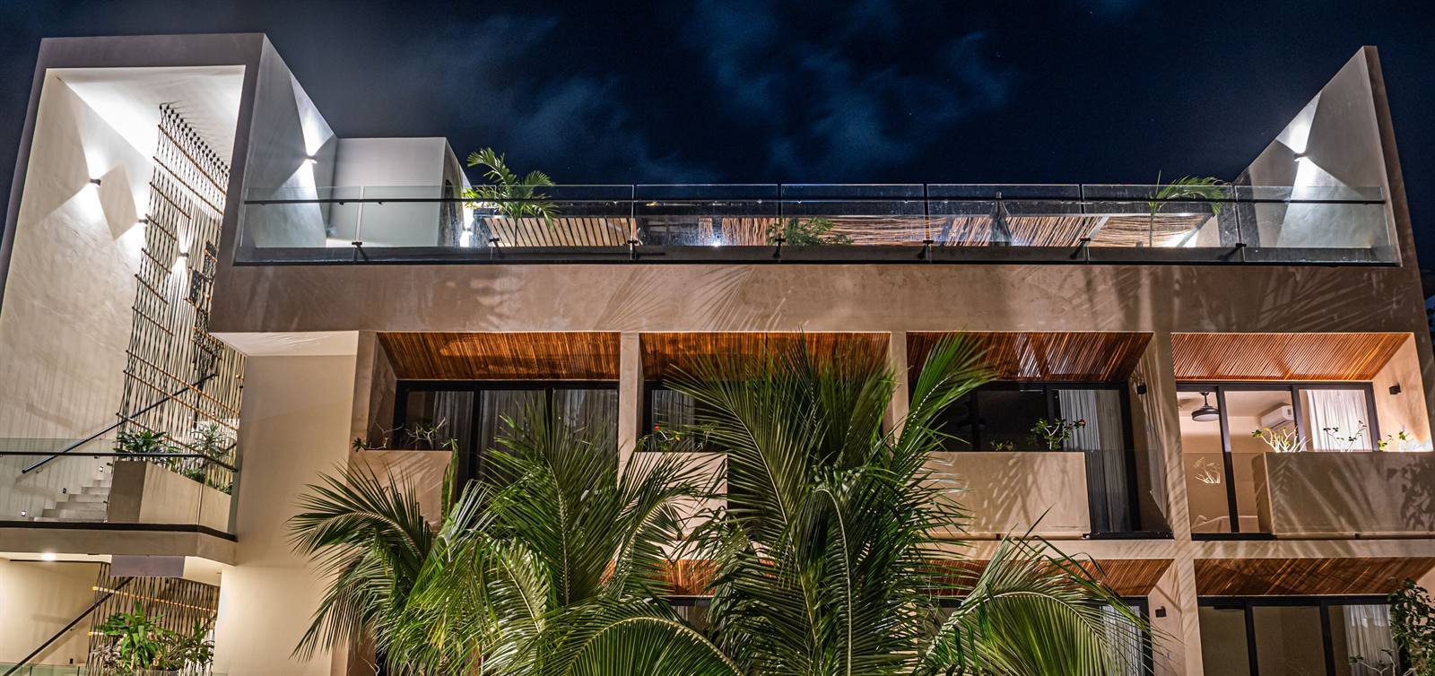 Moonshine Tulum Hotel: the building at night, with balconies and plants
